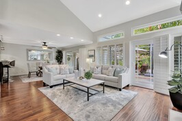 Vaulted living room with French doors to patio
