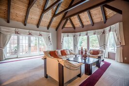 Vaulted-ceiling living room with stone fireplace