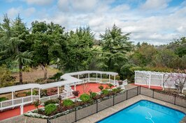 Upper deck view over pool and landscaped grounds